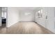 Bright living room showcasing wood-look floors, a window, and white trim at 1225 S Xavier St, Denver, CO 80219