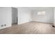 Spacious room featuring wood-look floors, bright walls, and a large window at 1225 S Xavier St, Denver, CO 80219