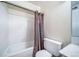 Bathroom features a white bathtub and shower with grey curtains at 12113 Melody Dr # 304, Denver, CO 80234