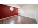 Empty bedroom showcasing hardwood floors, a large window, and a unique octagon-shaped window at 12113 Melody Dr # 304, Denver, CO 80234