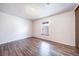 Spacious bedroom with wood floors and a large window at 12113 Melody Dr # 304, Denver, CO 80234