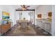 Cozy dining area with seating for six, updated flooring, and a view into the kitchen bar at 12113 Melody Dr # 304, Denver, CO 80234