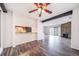 Open concept living room and kitchen area featuring updated flooring and stone fireplace at 12113 Melody Dr # 304, Denver, CO 80234