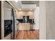 Modern kitchen featuring stainless steel appliances, light wood cabinets, and a contrasting black backsplash at 1700 Bassett St # 1321, Denver, CO 80202