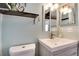 Updated bathroom featuring a modern vanity with sink, decorative shelves, and a neutral color palette at 1830 Newland Ct # 321, Lakewood, CO 80214