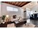 Bright living room featuring modern decor and a cozy seating area, wood ceilings, and large windows at 1830 Newland Ct # 321, Lakewood, CO 80214