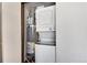 The utility closet features stacked washer and dryer next to the water heater at 1830 Newland Ct # 321, Lakewood, CO 80214