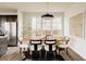 Bright dining room featuring a modern table setting, stylish chairs, and a large window for natural light at 11090 E 26Th Ave, Aurora, CO 80010