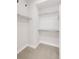 Walk-in closet featuring ample shelving space and a carpeted floor, offering excellent storage at 11090 E 26Th Ave, Aurora, CO 80010