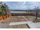 Expansive backyard featuring a fire pit and scenic lake views, perfect for outdoor enjoyment and relaxation at 4328 S Carr Ct, Littleton, CO 80123