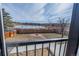 Backyard view with a fire pit and a pond with trees at 4328 S Carr Ct, Littleton, CO 80123