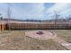 Backyard features fire pit with pond views, a wood fence and landscaping at 4328 S Carr Ct, Littleton, CO 80123
