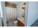 Cozy bathroom featuring a shower with white and gray striped curtain and modern vanity at 4328 S Carr Ct, Littleton, CO 80123