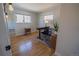 Bright bedroom features hardwood floors, windows, desk, and neutral paint at 4328 S Carr Ct, Littleton, CO 80123