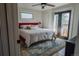Bright bedroom with a ceiling fan, access to a balcony, and a plush rug at 4328 S Carr Ct, Littleton, CO 80123