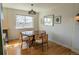 Charming dining room with a wooden table and chairs under a stylish light fixture at 4328 S Carr Ct, Littleton, CO 80123