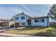 Charming two-story home with a brick accent and a green lawn at 4328 S Carr Ct, Littleton, CO 80123