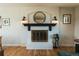 Elegant fireplace with a dark mantle and white brick surround at 4328 S Carr Ct, Littleton, CO 80123