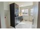 Modern kitchen featuring sleek black cabinetry, white floors and a view of the water at 4328 S Carr Ct, Littleton, CO 80123