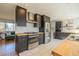 Modern kitchen with dark cabinets and stainless steel appliances at 4328 S Carr Ct, Littleton, CO 80123