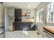 Bright kitchen with stainless steel appliances, black cabinets, and a butcher block countertop at 4328 S Carr Ct, Littleton, CO 80123