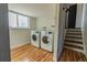 Convenient laundry room with updated machines, hardwood floors, and ample natural light at 4328 S Carr Ct, Littleton, CO 80123