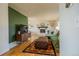 Inviting living room featuring a decorative fireplace, hardwood floors, and a cozy green sectional at 4328 S Carr Ct, Littleton, CO 80123