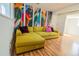 Living room featuring hardwood floors and a colorful mural wall at 4328 S Carr Ct, Littleton, CO 80123