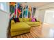 Lower-level living room with vibrant wall art and comfortable seating at 4328 S Carr Ct, Littleton, CO 80123