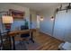 Bright office featuring hardwood floors, a desk, and barn doors, perfect for a productive workspace at 4328 S Carr Ct, Littleton, CO 80123