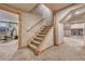 Carpeted basement staircase and finished basement with natural wood trim at 1410 Old Sequoia Ct, Franktown, CO 80116