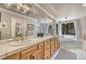 Bathroom with dual sinks, bathtub and walk-in shower with natural light from windows at 1410 Old Sequoia Ct, Franktown, CO 80116