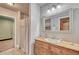 Bathroom featuring a wooden vanity, sink, and shower at 1410 Old Sequoia Ct, Franktown, CO 80116