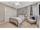 Bedroom featuring a metal framed bed, an accent chair, and floral wallpaper at 1410 Old Sequoia Ct, Franktown, CO 80116