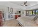 This bedroom features a ceiling fan, a dresser, and decor that reads 