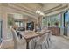 Elegant dining room with a wooden table, chandelier, and view of the living room at 1410 Old Sequoia Ct, Franktown, CO 80116