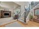 Spacious entryway featuring hardwood floors, staircase, and living room access at 1410 Old Sequoia Ct, Franktown, CO 80116