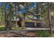 Beautiful two-story home with stone accents and a lush surrounding landscape at 1410 Old Sequoia Ct, Franktown, CO 80116