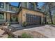 Charming two-story home featuring a stone facade and a three-car garage at 1410 Old Sequoia Ct, Franktown, CO 80116