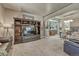 Open-concept living room with a TV, built-in shelves, and a dining area at 1410 Old Sequoia Ct, Franktown, CO 80116