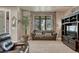 Comfortable living room with a brown leather couch, large window, and TV at 1410 Old Sequoia Ct, Franktown, CO 80116