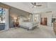Large main bedroom with vaulted ceilings, wood accent wall, and neutral decor at 1410 Old Sequoia Ct, Franktown, CO 80116