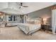 Spacious main bedroom featuring a cozy daybed, natural light, and soft carpeting at 1410 Old Sequoia Ct, Franktown, CO 80116