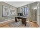 Bright home office featuring a large desk, stylish rug, and large window at 1410 Old Sequoia Ct, Franktown, CO 80116