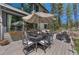 Outdoor patio with table, chairs, and an umbrella at 1410 Old Sequoia Ct, Franktown, CO 80116