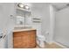 Well-lit bathroom with a granite countertop vanity, framed mirror, shelves, and glass shower at 7240 W Custer Ave # 301, Lakewood, CO 80226