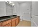 Bathroom featuring a granite countertop, wood cabinets and shower with glass door at 7240 W Custer Ave # 301, Lakewood, CO 80226