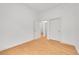 Bright bedroom featuring hardwood floors, white walls, and a doorway leading to additional rooms at 7240 W Custer Ave # 301, Lakewood, CO 80226