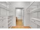 Spacious walk-in closet with adjustable shelving and drawers, leading to bathroom at 7240 W Custer Ave # 301, Lakewood, CO 80226