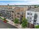 Aerial shot of The Lofts exterior with balconies and manicured landscaping on a sunny day at 7240 W Custer Ave # 301, Lakewood, CO 80226